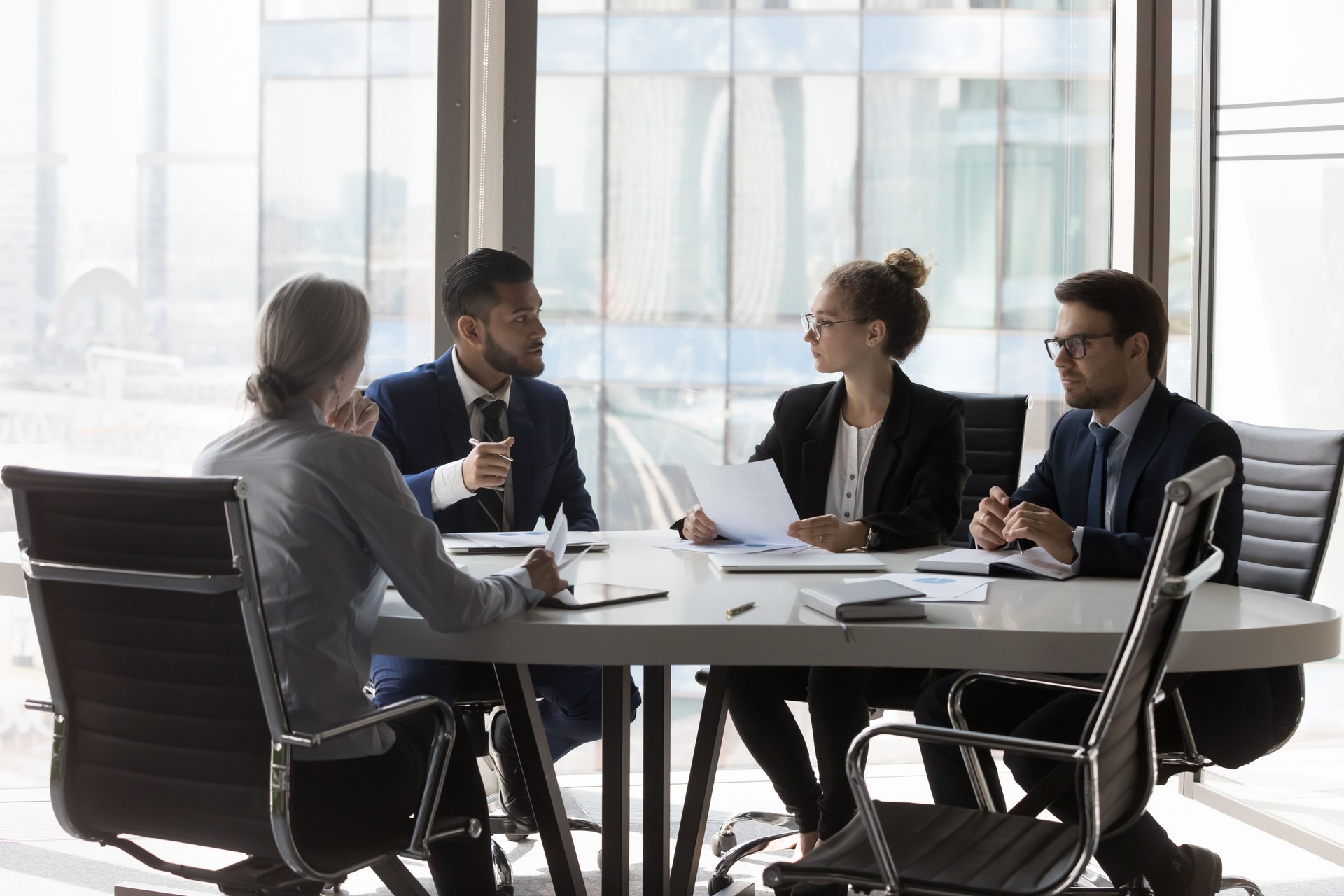 Busy millennial professional group reviewing startup marketing reports